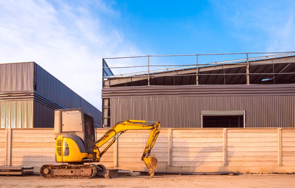 Mini,Excavator,On,The,Floor,In,Front,Of,Precast,Concrete